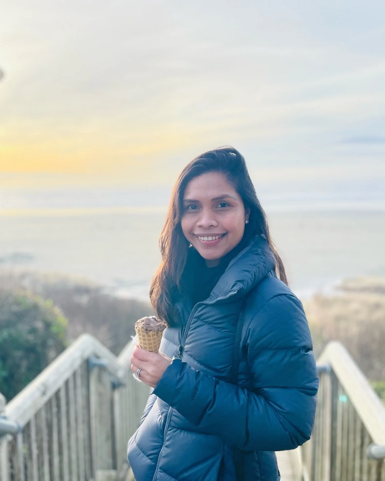 Flora May dela Cruz, wearing a navy blue jacket, holding an ice cream.